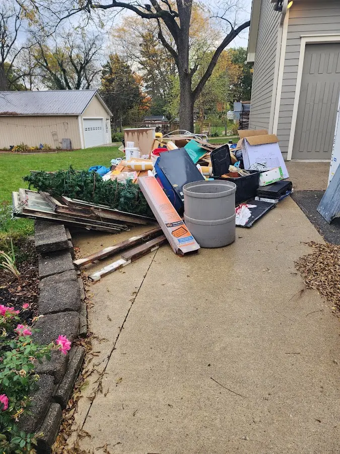 Dumpster being loaded with debris for 12 Yard Dumpster Rental in Nokomis